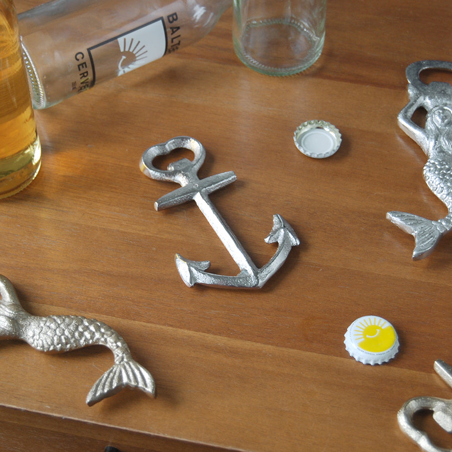 Silver anchor bottle opener on wooden table