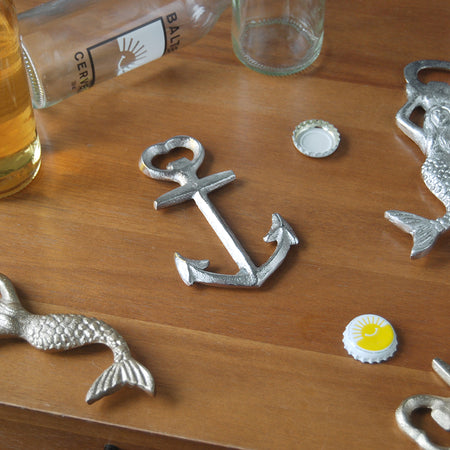 Silver anchor bottle opener on wooden table