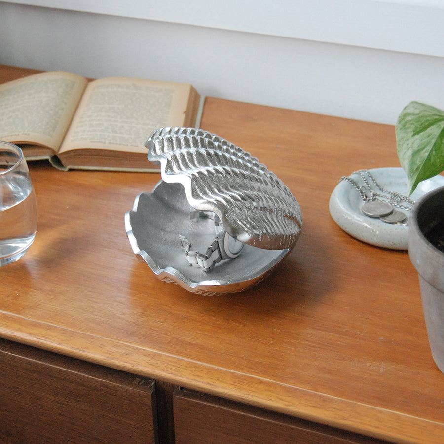 Textured silver shell dish displayed on timber furniture