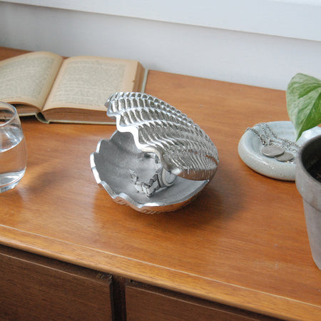 Textured silver shell dish displayed on timber furniture