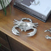 Metallic crab-shaped trinket dish styled in a coastal-inspired interior