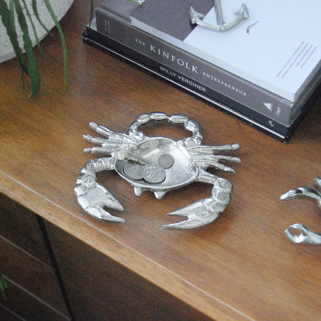 Metallic crab-shaped trinket dish styled in a coastal-inspired interior