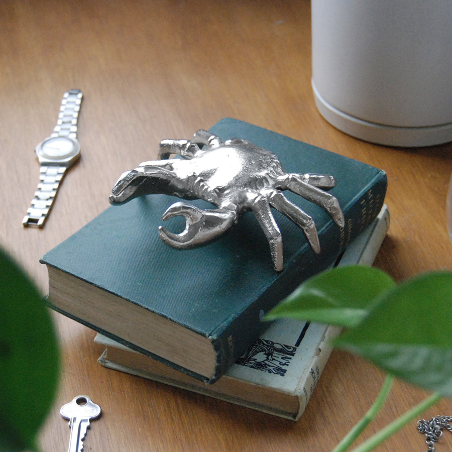 Metallic silver crab figurine used as coastal home décor accent