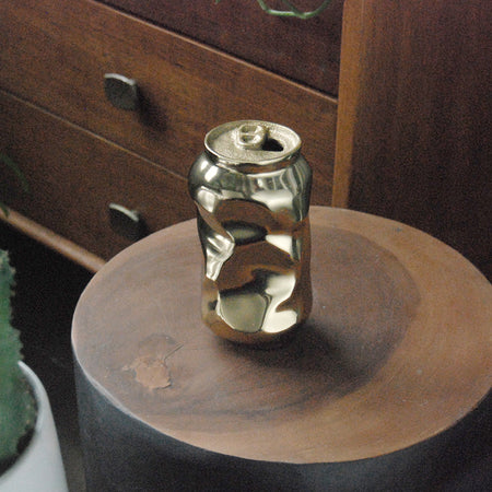 Metallic gold vase sculpture shaped like a crushed drink can