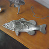 Textured silver fish dish displayed with jewellery and accessories