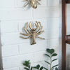 Gold lobster wall mount hanging on white brick wall with built-in hanger