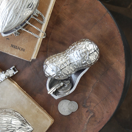Sculptural silver peanut container used for storing small items