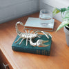 Gold metal scorpion sculpture mounted using back hanger