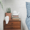 Whimsical white snail decor piece styled in a fresh, plant-filled space