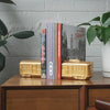 Gold resin Melbourne tram bookends styled with vintage Melbourne books on timber cabinet