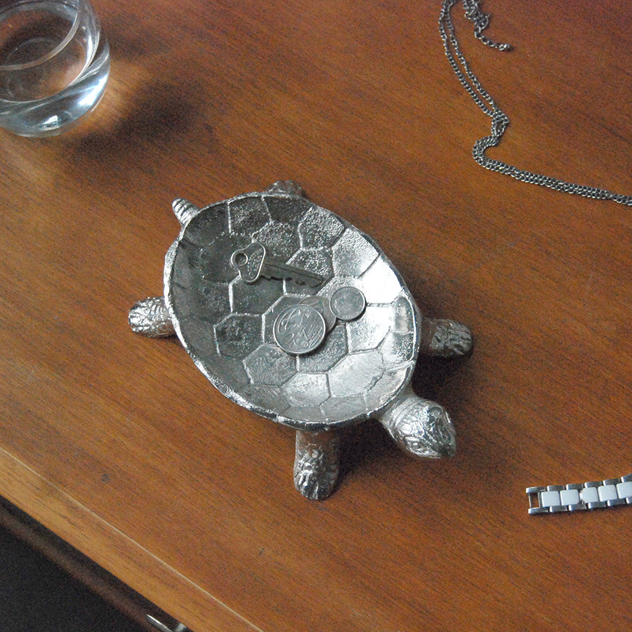 Sculptural silver turtle bowl used for storing small items indoors
