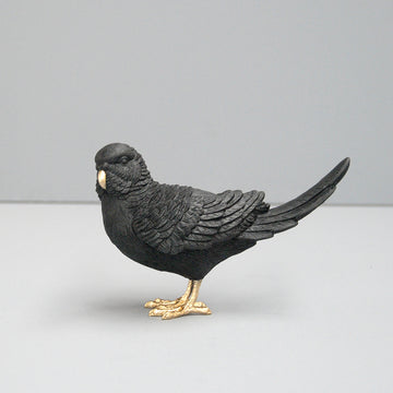 Sculptural black budgie figurine with gold detail