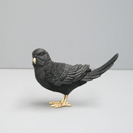 Sculptural black budgie figurine with gold detail