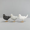 Set of three resin budgie sculptures in black, grey, and white with gold accents