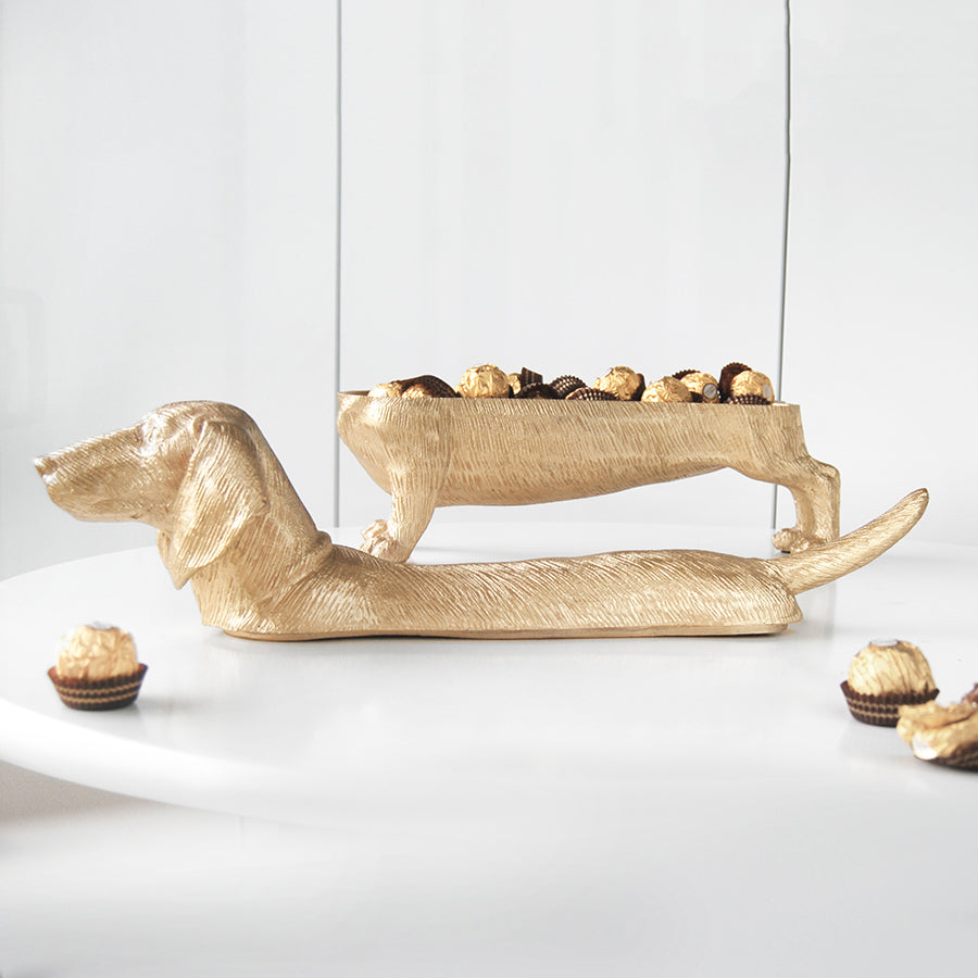 Gold dachshund bowl sculpture filled with chocolates