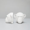Sculptural white bookends shaped like monkey heads