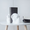 White resin monkey bookends holding black book