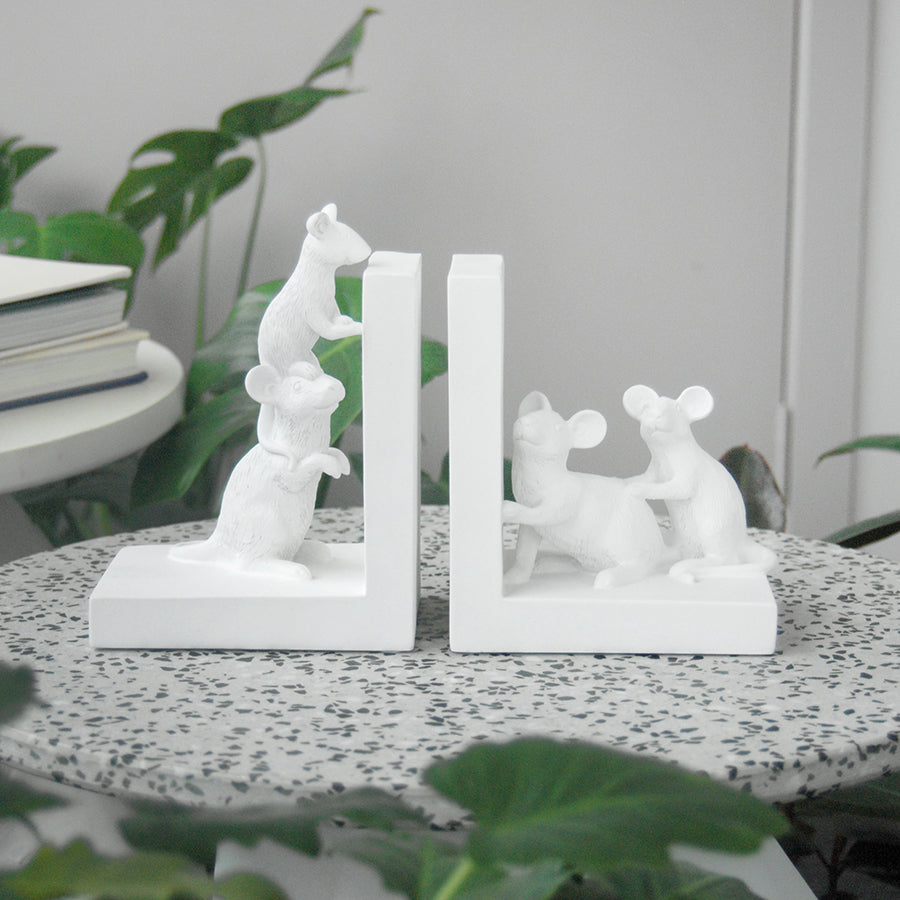 Matte white resin mice bookends styled on terrazzo side table