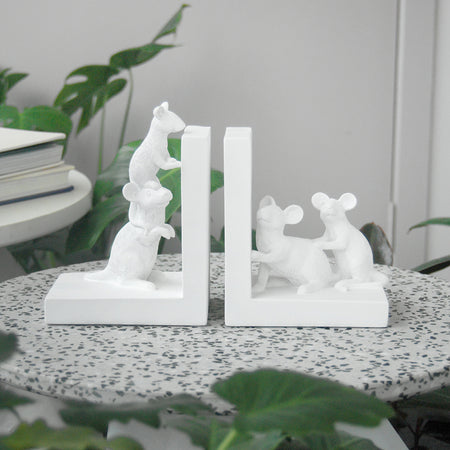 Matte white resin mice bookends styled on terrazzo side table