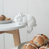 Cute white rabbit ornament lounging off the edge in a modern interior