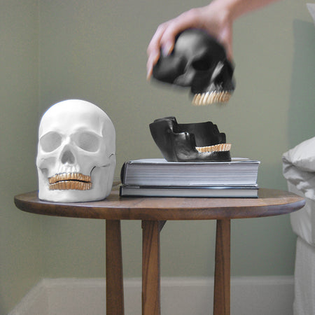 Matte black skull trinket box with gold tooth and open lid