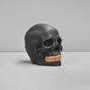 Close-up of sculpted skull detail and gold tooth finish