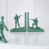 Green army soldier bookends by White Moose styled on white bookshelf