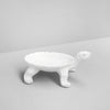 White resin turtle dish sculpture with shallow shell tray on minimalist background