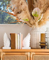 Modern decorative wing bookends in matte finish styled in warm interior